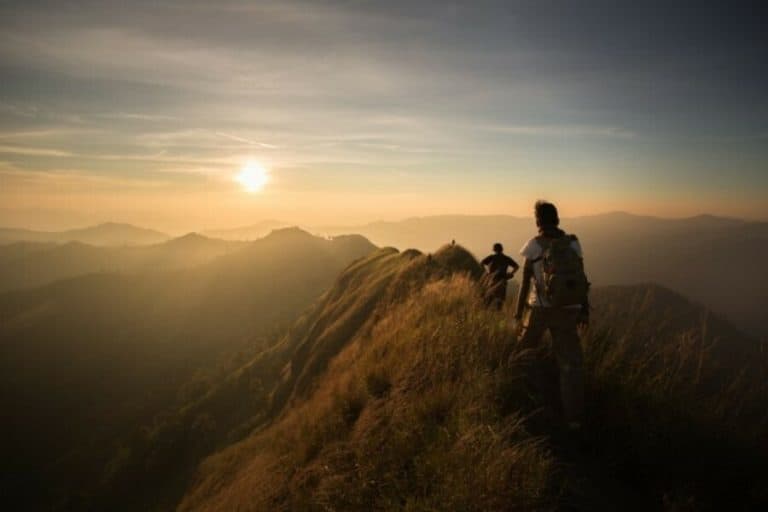 People hiking through mountain tops